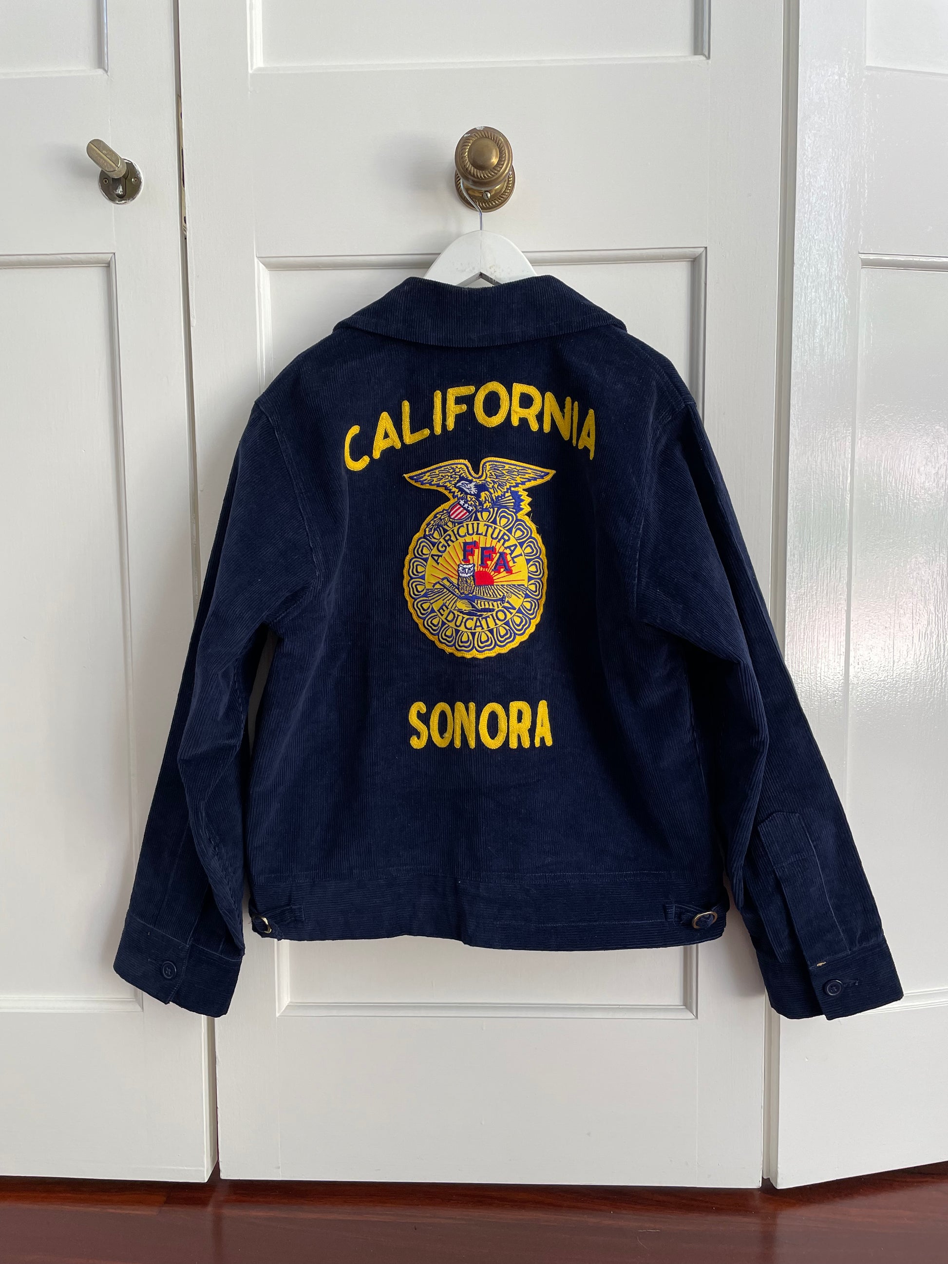 Vintage California FFA (Future Farmers of America) corduroy jacket from the 90s. Embroidery "California Sonora" and "Matt Baker" at left chest. FFA patches on both front and back